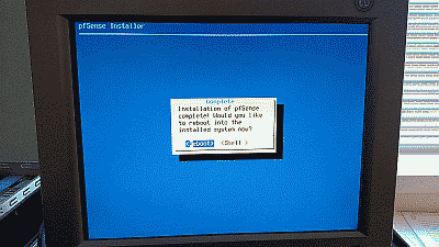Screenshot showing the prompt to reboot the system after pfSense completes installation